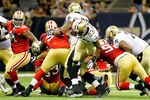 NEW ORLEANS, LA - AUGUST 12:  Pierre Thomas #23 of the New Orleans Saints runs against San Francisco 49er defedners during a preseason game at Louisiana Superdome on August 12, 2011 in New Orleans, Louisiana.  (Photo by Sean Gardner/Getty Images)