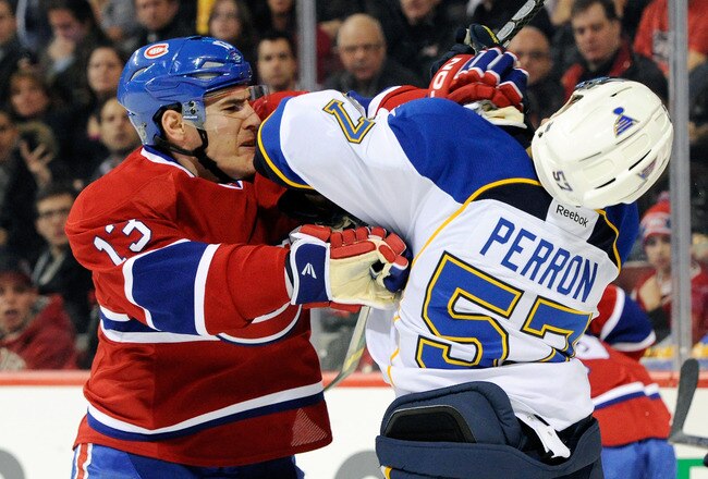 MONTREAL, CANADA - JANUARY 10:  Mike Cammalleri #13 of the Montreal Canadiens and David Perron #57 of the St. Louis Blues mix it up during the NHL game at the Bell Centre on January 10, 2012 in Montreal, Quebec, Canada.  (Photo by Richard Wolowicz/Getty Images)