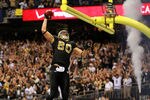 NEW ORLEANS, LA - JANUARY 07:   Jimmy Graham #80 of the New Orleans Saints celebrates by dunking the football over the crossbar after scoring a touchdown in the third quarter against the Detroit Lions during their 2012 NFC Wild Card Playoff game at Mercedes-Benz Superdome on January 7, 2012 in New Orleans, Louisiana.  (Photo by Ronald Martinez/Getty Images)