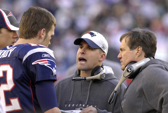 New England Patriots coach Bill Belichick (right) and Josh McDaniels (center) with quarterback Tom Brady   against the New York Jets in  an NFL wild card playoff game Jan. 7, 2007 in Foxborough.  The Pats won 37 - 16. (Photo by Al Messerschmidt/Getty Images)