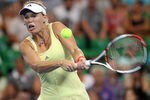 PERTH, AUSTRALIA - JANUARY 04:  Caroline Wozniacki of Denmark plays a shot in her singles match against Tsvetana Pironkova of Bulgaria during day five of the 2012 Hopman Cup at The Burswood Dome on January 4, 2012 in Perth, Australia.  (Photo by Paul Kane/Getty Images)