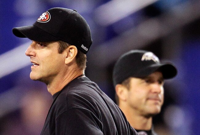 BALTIMORE, MD - NOVEMBER 24:  Head coach Jim Harbaugh (L) of the San Francisco 49ers and his brother, head coach John Harbaugh (R) of the Baltimore Ravens stand next to each other before the start of their game at M&T Bank Stadium on November 24, 2011 in Baltimore, Maryland.  (Photo by Rob Carr/Getty Images)