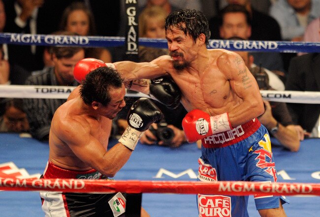 LAS VEGAS, NV - NOVEMBER 12:  (R-L) Manny Pacquiao throws a right to the head of Juan Manuel Marquez during the WBO world welterweight title fight at the MGM Grand Garden Arena on November 12, 2011 in Las Vegas, Nevada.  (Photo by Ethan Miller/Getty Images)