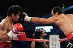 LAS VEGAS, NV - NOVEMBER 12:  (R-L) Juan Manuel Marquez throws a left to the head of Manny Pacquiao during the WBO world welterweight title fight at the MGM Grand Garden Arena on November 12, 2011 in Las Vegas, Nevada.  (Photo by Harry How/Getty Images)