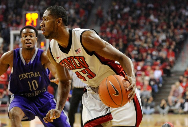 LAS VEGAS, NV - DECEMBER 28:  Mike Moser #43 of the UNLV Rebels drives against Mark Rutledge #10 of the Central Arkansas Bears during their game at the Thomas & Mack Center December 28, 2011 in Las Vegas, Nevada. UNLV won 124-75.  (Photo by Ethan Miller/Getty Images)