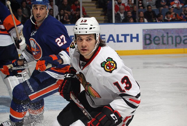 UNIONDALE, NY - DECEMBER 08:  Daniel Carcillo #13 of the Chicago Blackhawks skates against the New York Islanders at the Nassau Veterans Memorial Coliseum on December 8, 2011 in Uniondale, New York.  (Photo by Bruce Bennett/Getty Images)