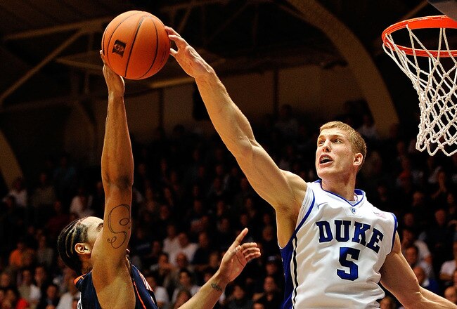 DURHAM, NC - JANUARY 12:  Mason Pumlee #5 of the Duke Blue Devils blocks a shot by Mike Scott #23 of the Virginia Cavaliers during play at Cameron Indoor Stadium on January 12, 2012 in Durham, North Carolina. Duke won 61-58.  (Photo by Grant Halverson/Getty Images)