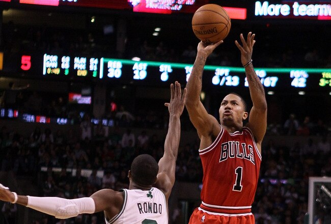 BOSTON, MA - JANUARY 13:  Derrick Rose #1 of the Chicago Bulls takes a shot as Rajon Rondo #9 of the Boston Celtics defends on January 13, 2012 at TD Garden in Boston, Massachusetts. The Chicago Bulls defeated the Boston Celtics 88-79. NOTE TO USER: User expressly acknowledges and agrees that, by downloading and or using this photograph, User is consenting to the terms and conditions of the Getty Images License Agreement.  (Photo by Elsa/Getty Images)