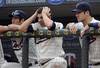 MINNEAPOLIS MN- AUGUST 27:  From left, Tsuyoshi Nishioka, Danny Valencia and Joe Mauer of the Minnesota Twins watch the final inning of their game against the Detroit Tigers as they lose 6-4 on August 27, 2011 at Target Field in Minneapolis, Minnesota. (Photo by Craig Lassig/Getty Images)