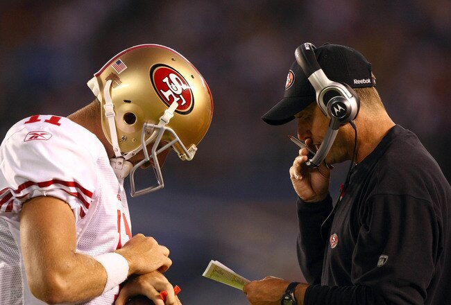 SAN DIEGO, CA - SEPTEMBER 1:  Head Coach Jim Harbaugh of the San Francisco 49ers speaks with Starting Quarterback Alex Smith #11 on the field during their preseason NFL Game against  the San Diego Chargers on September 1, 2011 at Qualcomm Stadium in San DIego, California. (Photo by Donald Miralle/Getty Images)