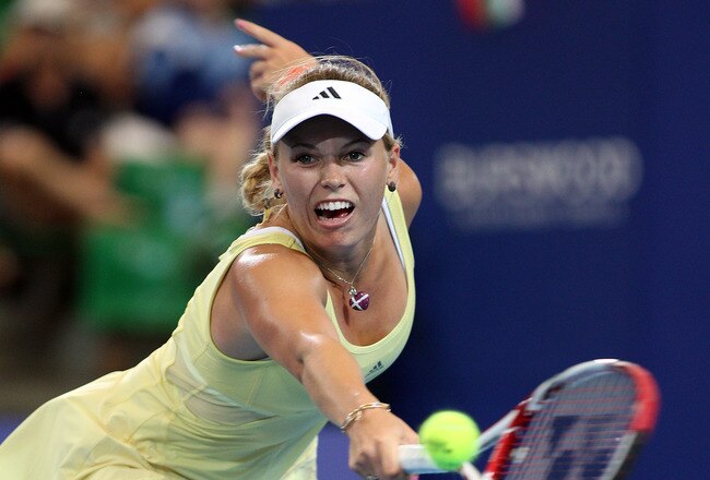 PERTH, AUSTRALIA - JANUARY 04:  Caroline Wozniacki of Denmark plays a shot in her singles match against Tsvetana Pironkova of Bulgaria during day five of the 2012 Hopman Cup at The Burswood Dome on January 4, 2012 in Perth, Australia.  (Photo by Paul Kane/Getty Images)