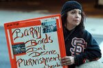 SAN FRANCISCO, CA - DECEMBER 16:  A fan of former Major League Baseball player Barry Bonds holds a sign outside of federal court on December 16, 2011 in San Francisco, California.  Former Major League Baseball player Barry Bonds was sentenced to 30 days of home confinement and two years probation after a jury found Barry Bonds guilty on one count of obstruction of justice and was a hung jury on three counts of perjury for lying to a grand jury about his use of performance enhancing drugs.  (Photo by Justin Sullivan/Getty Images)