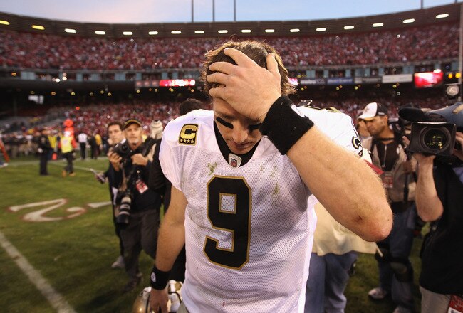 SAN FRANCISCO, CA - JANUARY 14:  Drew Brees #9 of the New Orleans Saints reacts after they lost their game against the the San Francisco 49ers in the NFC Divisional playoff game at Candlestick Park on January 14, 2012 in San Francisco, California.  (Photo by Ezra Shaw/Getty Images)