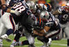FOXBORO, MA - JANUARY 14:  Tim Tebow #15 of the Denver Broncos is sacked by Gerard Warren #98 and Rob Ninkovich #50 of the New England Patriots in the third quarter during their AFC Divisional Playoff Game at Gillette Stadium on January 14, 2012 in Foxboro, Massachusetts.  (Photo by Al Bello/Getty Images)