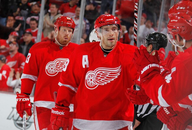 DETROIT, MI - JANUARY 12: Pavel Datsyuk #13 of the Detroit Red Wings celebrates with the bench after a Johan Franzen #93 third period goal while playing the Phoenix Coyotes at Joe Louis Arena on January 12, 2011 in Detroit, Michigan. Detroit won the game 3-2 in a shootout. (Photo by Gregory Shamus/Getty Images)