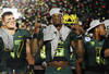 PASADENA, CA - JANUARY 02:  (L-R) Kiko Alonso #47, quarterback Darron Thomas #5 and Eddie Pleasant #11 of the Oregon Ducks celebrates the Ducks 45-38 victory over the Wisconsin Badgers at the 98th Rose Bowl Game on January 2, 2012 in Pasadena, California.  (Photo by Harry How/Getty Images)