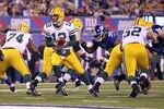 EAST RUTHERFORD, NJ - DECEMBER 04:  Aaron Rodgers #12 of the Green Bay Packers turns to hand the ball off against the New York Giants at MetLife Stadium on December 4, 2011 in East Rutherford, New Jersey. The Packers won 38-35. (Photo by Nick Laham/Getty Images)