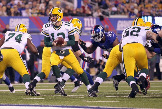EAST RUTHERFORD, NJ - DECEMBER 04:  Aaron Rodgers #12 of the Green Bay Packers turns to hand the ball off against the New York Giants at MetLife Stadium on December 4, 2011 in East Rutherford, New Jersey. The Packers won 38-35. (Photo by Nick Laham/Getty Images)