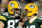 GREEN BAY, WI - DECEMBER 25:  Jordy Nelson #87 and quarterback Aaron Rodgers #12 of the Green Bay Packers celebrate a touchdown in the fourth quarter against the Chicago Bears at Lambeau Field on December 25, 2011 in Green Bay, Wisconsin.  (Photo by Matthew Stockman/Getty Images)