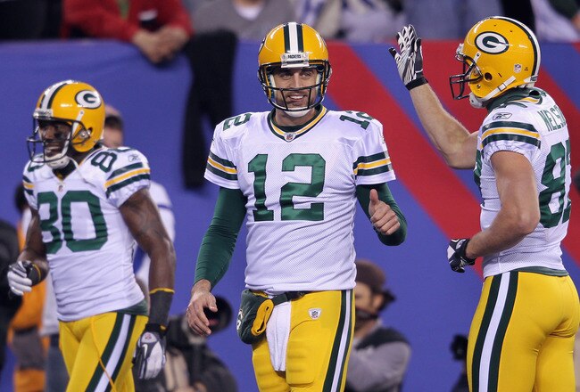 EAST RUTHERFORD, NJ - DECEMBER 04:  (L-R) Donald Driver #80, Aaron Rodgers #12 and Jordy Nelson #87 of the Green Bay Packers celebrate against the New York Giants at MetLife Stadium on December 4, 2011 in East Rutherford, New Jersey.  (Photo by Nick Laham/Getty Images)