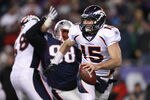 FOXBORO, MA - JANUARY 14:  Tim Tebow #15 of the Denver Broncos looks to pass against the New England Patriots during their AFC Divisional Playoff Game at Gillette Stadium on January 14, 2012 in Foxboro, Massachusetts.  (Photo by Elsa/Getty Images)