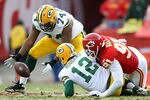 KANSAS CITY, MO - DECEMBER 18:  Marshall Newhouse #74 of the Green Bay Packers picks up an Aaron Rodgers #12 fumble caused by Tamba Hali #91 of the Kansas City Chiefs during the game on December 18, 2011 at Arrowhead Stadium in Kansas City, Missouri.  (Photo by Jamie Squire/Getty Images)