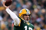 GREEN BAY, WI - JANUARY 15:  Aaron Rodgers #12 of the Green Bay Packers drops back to pass against the New York Giants during their NFC Divisional playoff game at Lambeau Field on January 15, 2012 in Green Bay, Wisconsin.  (Photo by Jonathan Daniel/Getty Images)