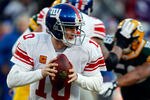 GREEN BAY, WI - JANUARY 15:   Eli Manning #10 of the New York Giants drops back to pass against the Green Bay Packers during their NFC Divisional playoff game at Lambeau Field on January 15, 2012 in Green Bay, Wisconsin.  (Photo by Scott Boehm/Getty Images)