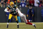 GREEN BAY, WI - JANUARY 15:   Deon Grant #34 of the New York Giants tackles  Aaron Rodgers #12 of the Green Bay Packers during their NFC Divisional playoff game at Lambeau Field on January 15, 2012 in Green Bay, Wisconsin.  (Photo by Jamie Squire/Getty Images)