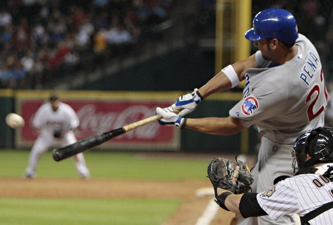 HOUSTON - AUGUST 16:  Carlos Pena #22 of the Chicago Cubs doubles in the sixth inning against the Houston Astros at Minute Maid Park on August 16, 2011 in Houston, Texas.  (Photo by Bob Levey/Getty Images)