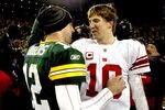 GREEN BAY, WI - DECEMBER 26:  Aaron Rodgers #12 of the Green Bay Packers is congratulated by Eli Manning #10 of the New York Giants after their game at Lambeau Field on December 26, 2010 in Green Bay, Wisconsin.  (Photo by Matthew Stockman/Getty Images)