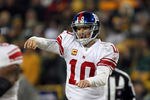 GREEN BAY, WI - JANUARY 15:  Eli Manning #10 of the New York Giants passes against the Green Bay Packers during their NFC Divisional playoff game at Lambeau Field on January 15, 2012 in Green Bay, Wisconsin.  (Photo by Jonathan Daniel/Getty Images)