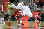 LOUISVILLE, KY - DECEMBER 23:  Russ Smith #2 of the Louisville Cardinals and Derrick Gordon #5 of the Western Kentucky Hilltoppers reach for a loose ball during the game at KFC YUM! Center on December 23, 2011 in Louisville, Kentucky.  Louisville won 70-60.  (Photo by Andy Lyons/Getty Images)
