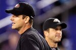 BALTIMORE, MD - NOVEMBER 24:  Head coach Jim Harbaugh (L) of the San Francisco 49ers and his brother, head coach John Harbaugh (R) of the Baltimore Ravens stand next to each other before the start of their game at M&T Bank Stadium on November 24, 2011 in Baltimore, Maryland.  (Photo by Rob Carr/Getty Images)
