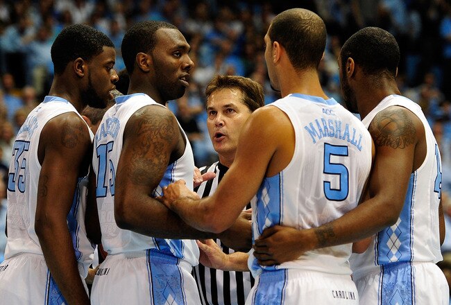CHAPEL HILL, NC - JANUARY 07:  An official warns the North Carolina Tar Heels huddle after a brief scuffle with the Boston College Eagles during play at the Dean Smith Center on January 7, 2012 in Chapel Hill, North Carolina.  (Photo by Grant Halverson/Getty Images)