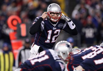 FOXBORO, MA - JANUARY 14:  Tom Brady #12 of the New England Patriots gestures as he calls signals out down the line of scrimmage against the Denver Broncos during their AFC Divisional Playoff Game at Gillette Stadium on January 14, 2012 in Foxboro, Massachusetts.  (Photo by Elsa/Getty Images)