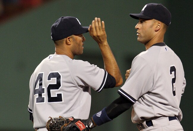 BOSTON, MA - AUGUST 05:  Mariano Rivera #42 and Derek Jeter #3 of the New York Yankees celebrate the win over the Boston Red Sox on August 5, 2011 at Fenway Park in Boston, Massachusetts. The New York Yankees defeated the Boston Red Sox 3-2.  (Photo by Elsa/Getty Images)