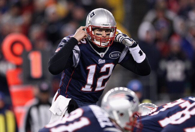 FOXBORO, MA - JANUARY 14:  Tom Brady #12 of the New England Patriots gestures as he calls signals out down the line of scrimmage against the Denver Broncos during their AFC Divisional Playoff Game at Gillette Stadium on January 14, 2012 in Foxboro, Massachusetts.  (Photo by Elsa/Getty Images)