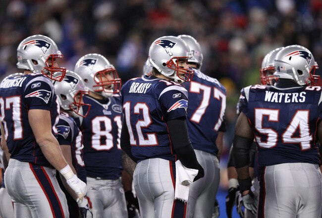 FOXBORO, MA - JANUARY 14:  (L-R) Rob Gronkowski #87, Aaron Hernandez #81, Tom Brady #12 and Brian Waters #54 of the New England Patriots look on against the Denver Broncos during their AFC Divisional Playoff Game at Gillette Stadium on January 14, 2012 in Foxboro, Massachusetts.  (Photo by Elsa/Getty Images)