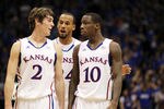 LAWRENCE, KS - JANUARY 04:  Connor Teahen #2, Travis Releford #24 and Tyshawn Taylor #10 of the Kansas Jayhawks confer during the game against the Kansas State Wildcats on January 4, 2012 at Allen Fieldhouse in Lawrence, Kansas.  (Photo by Jamie Squire/Getty Images)