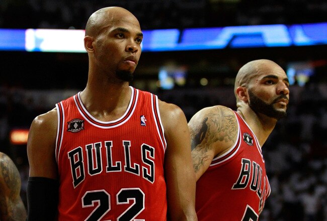MIAMI, FL - MAY 22:  (L-R) Taj Gibson #22 and Carlos Boozer #5 of the Chicago Bulls look on against the Miami Heat in Game Three of the Eastern Conference Finals during the 2011 NBA Playoffs on May 22, 2011 at American Airlines Arena in Miami, Florida.  NOTE TO USER: User expressly acknowledges and agrees that, by downloading and or using this photograph, User is consenting to the terms and conditions of the Getty Images License Agreement.  (Photo by Marc Serota/Getty Images)