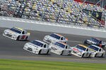 DAYTONA BEACH, FL - JANUARY 14:  Carl Edwards, driver of the #99 Fastenal Ford, and A.J. Allmendinger, driver of the #22 Shell/Pennzoil Dodge, lead a pack of cars through the tri-oval during Daytona Preseason Thunder at Daytona International Speedway on January 14, 2012 in Daytona Beach, Florida.  (Photo by Jared C. Tilton/Getty Images for NASCAR)