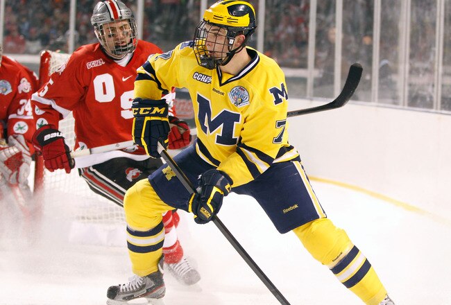 CLEVELAND, OH - JANUARY 15: Phil Di Giuseppe #7 of the Michigan Wolverines looks to pass the puck in front of Brandon Martell #5 of the Ohio State Buckeys during the Frozen Diamond Faceoff at Progressive Field on January 15, 2012 in Cleveland, Ohio. (Photo by Gregory Shamus/Getty Images)