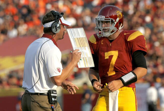 LOS ANGELES - SEPTEMBER 17:   Head coach Lane Kiffin and quarterback Matt Barkley #7 of the USC Trojans confer during the game with the Syracuse Orangemen at the Los Angeles Memorial Coliseum on September 17, 2011 in Los Angeles, California. USC won 38-17.   (Photo by Stephen Dunn/Getty Images)