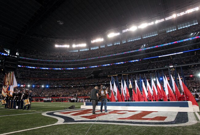 ARLINGTON, TX - FEBRUARY 06:  Singer Christina Aguilera sings the National Anthem during Super Bowl XLV between the Pittsburgh Steelers and the Green Bay Packers at Cowboys Stadium on February 6, 2011 in Arlington, Texas.  (Photo by Jamie Squire/Getty Images)