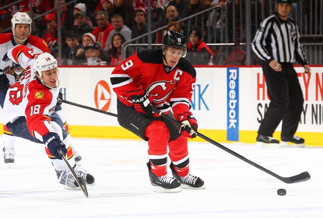 NEWARK, NJ - JANUARY 06:  Zach Parise #9 of the New Jersey Devils skates with the puck as Shawn Matthias #18 of the Florida Panthers defends during their game on January 6, 2012 at The Prudential Center in Newark, New Jersey  (Photo by Al Bello/Getty Images)