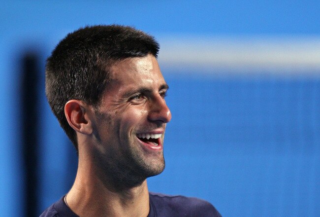 MELBOURNE, AUSTRALIA - JANUARY 11:  Novak Djokovic of Serbia laughs during a practice session prior to the 2012 Australian Open at Rod Laver Arena on January 11, 2012 in Melbourne, Australia.  (Photo by Scott Barbour/Getty Images)