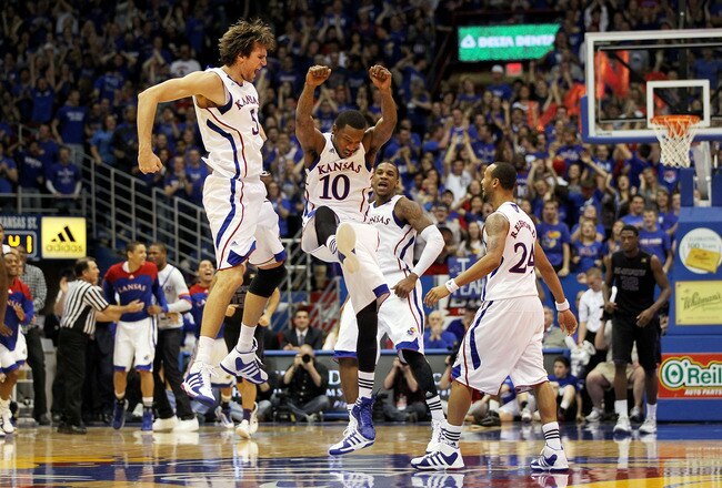LAWRENCE, KS - JANUARY 04:  Jeff Withey #5, Tyshawn Taylor #10, Thomas Robinson #0 and Travis Rutherford #24 of the Kansas Jayhawks celebrate after scoring during the game against the Kansas State Wildcats on January 4, 2012 at Allen Fieldhouse in Lawrence, Kansas.  (Photo by Jamie Squire/Getty Images)
