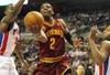 AUBURN HILLS, MI - DECEMBER 28:  Kyrie Irving #2 of the Cleveland Cavaliers gets a shot off between Rodney Stuckey #3 and Greg Monroe #10 of the Detroit Pistons on December 28, 2011 at the Palace of Auburn Hills in Auburn Hills, Michigan.  NOTE TO USER: User expressly acknowledges and agrees that, by downloading and or using this photograph, User is consenting to the terms and conditions of the Getty Images License Agreement. (Photo by Gregory Shamus/Getty Images)
