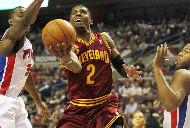 AUBURN HILLS, MI - DECEMBER 28:  Kyrie Irving #2 of the Cleveland Cavaliers gets a shot off between Rodney Stuckey #3 and Greg Monroe #10 of the Detroit Pistons on December 28, 2011 at the Palace of Auburn Hills in Auburn Hills, Michigan.  NOTE TO USER: User expressly acknowledges and agrees that, by downloading and or using this photograph, User is consenting to the terms and conditions of the Getty Images License Agreement. (Photo by Gregory Shamus/Getty Images)